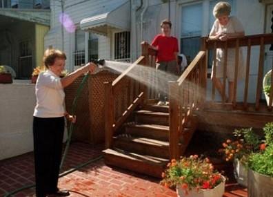 Ginny on the left, holding the hose. Credit: Patterson Park Neighborhood Association